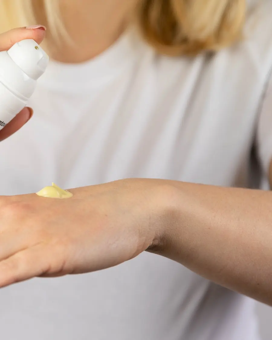Specialist dispensing a professional skincare product during a consultation