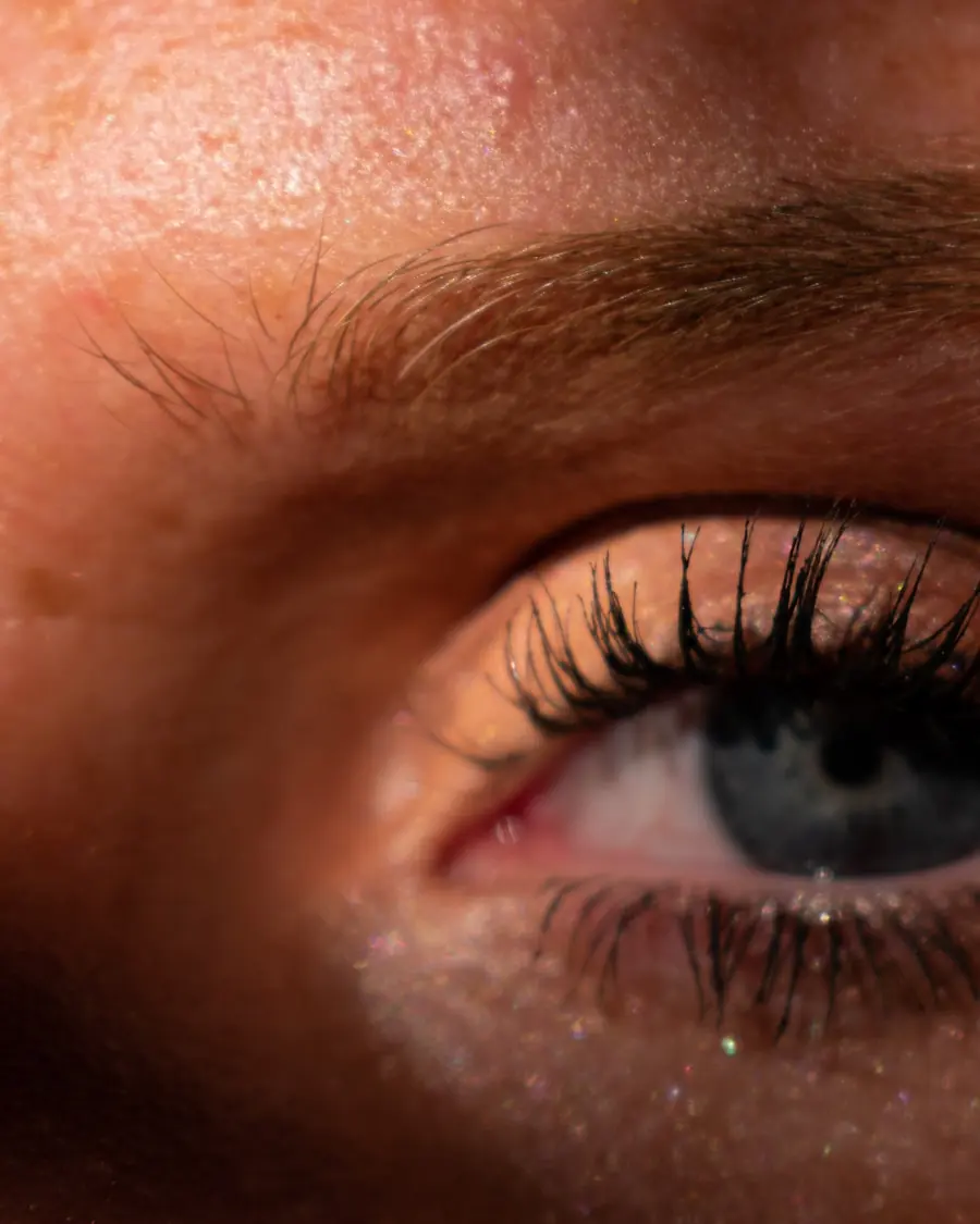 Close-up of shaped brows and lifted lashes in warm light